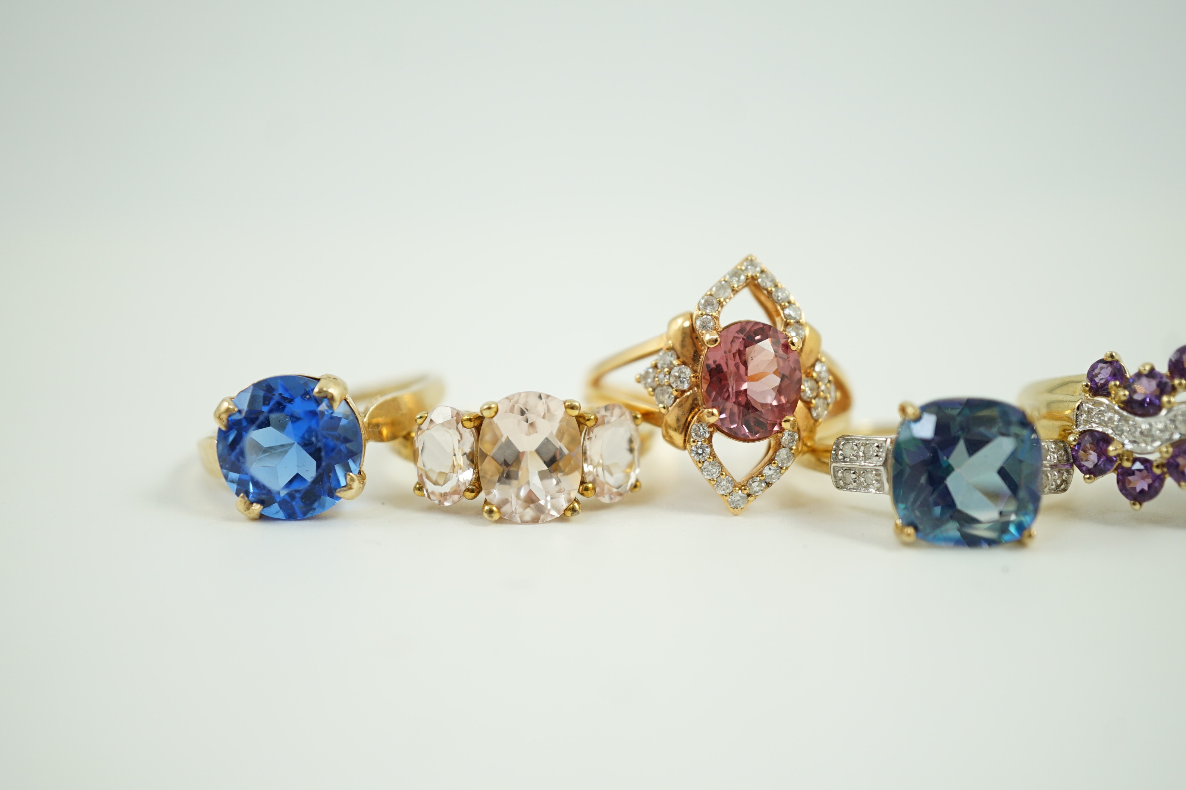 Four assorted modern 9ct gold and gem set rings and a similar 9k gem set ring, gross weight 16 grams.